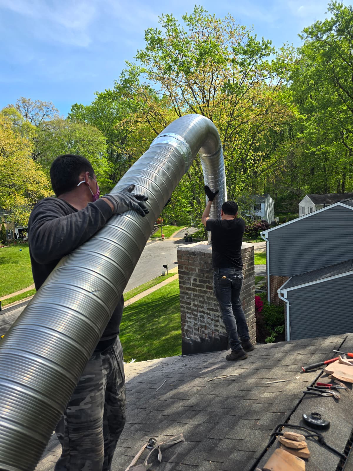 ChimmerJim technician installing a stainless steel chimney liner